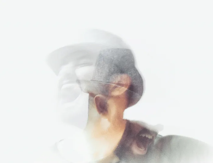 Blurred portrait of a man wearing a hat