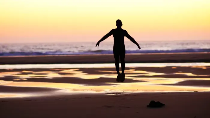 Beach and distant figure in sunset light