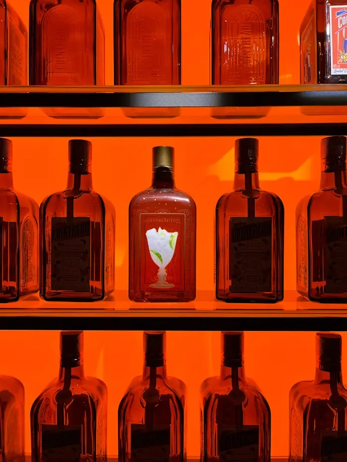Rows of bottles glowing red on a shelf